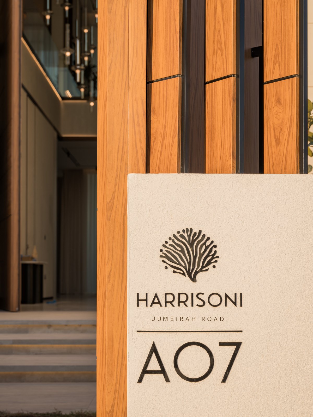 Harrisoni A07 — branded villa signage at the entrance