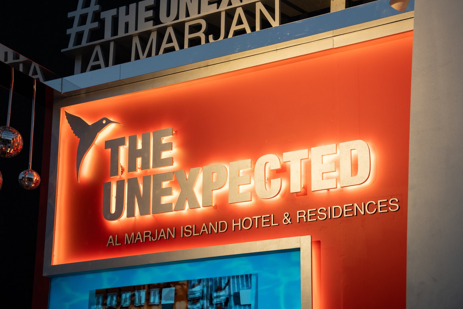 The Unexpected — backlit signage at the booth